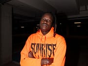 “ZG95 VOL. 2” il nuovo Mixtape di Mboss a man in an orange hoodie with his arms crossed